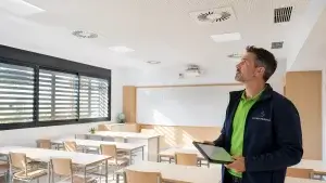 Técnico de Climatermia revisando la climatización y ventilación de un aula de colegio en Madrid
